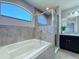 Beautiful bathroom featuring a large soaking tub and a glass enclosed shower at 2863 Harlow Ave, St Cloud, FL 34772