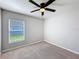 Neutrally decorated bedroom with plush carpeting and modern ceiling fan at 2863 Harlow Ave, St Cloud, FL 34772