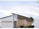 Modern home exterior featuring a two-car garage, neutral color palette and clean, simple landscaping at 1017 Randall St, Orlando, FL 32805