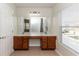 Bathroom with a double sink vanity, tiled floor, and a large mirror at 1201 Berkman Cir, Sanford, FL 32771