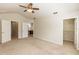 Spacious bedroom featuring a ceiling fan, neutral carpet, and an ensuite bathroom and walk-in closet at 1201 Berkman Cir, Sanford, FL 32771