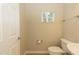 Clean powder room with a pedestal sink, toilet, and small window at 1201 Berkman Cir, Sanford, FL 32771