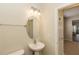 Clean powder room featuring a pedestal sink, mirror and light fixture at 1201 Berkman Cir, Sanford, FL 32771