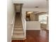 Carpeted staircase leading upstairs with views of the kitchen and living areas at 1201 Berkman Cir, Sanford, FL 32771