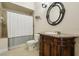 Bathroom featuring tile flooring, commode, decorative vanity and shower with a curtain at 1220 Lake Mills Rd, Chuluota, FL 32766