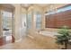 Well-lit bathroom with soaking tub, a glass-enclosed shower, and neutral color palette at 1220 Lake Mills Rd, Chuluota, FL 32766