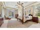 Bright main bedroom with tray ceiling, neutral tones, and outdoor view to the hot tub at 1220 Lake Mills Rd, Chuluota, FL 32766