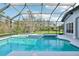 The backyard has a screened-in pool with a connecting spa, as well as greenery and open views of nature at 1220 Lake Mills Rd, Chuluota, FL 32766