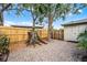 View of fully fenced-in backyard with mature trees and xeriscape at 1320 Golfview St, Orlando, FL 32804