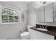 The bathroom features a decorative mirror, granite countertops, and a garden window at 1320 Golfview St, Orlando, FL 32804