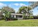 Well-maintained single-story home with a front yard featuring mature trees and landscaping at 1320 Golfview St, Orlando, FL 32804