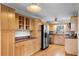 Well-lit kitchen features wood cabinets, stainless steel appliances, and generous countertop space at 1320 Golfview St, Orlando, FL 32804