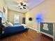 Bedroom with wood floors, ample light, ceiling fan and a closet at 13226 Zori Ln, Windermere, FL 34786