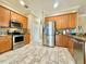 Modern kitchen featuring stainless steel appliances, granite countertops, and tile flooring at 13226 Zori Ln, Windermere, FL 34786