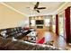 Spacious living room with stone accent wall, fireplace, and sliding doors to the lanai at 13226 Zori Ln, Windermere, FL 34786