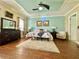 Serene main bedroom with tray ceiling, soft colors, and wood flooring at 13226 Zori Ln, Windermere, FL 34786