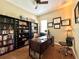 Office space with a built-in bookcase, hardwood floors, and natural lighting at 13226 Zori Ln, Windermere, FL 34786