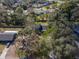 An aerial view of a home nestled within a residential neighborhood, enveloped by mature trees and greenery at 137 Stevens Ave, Chuluota, FL 32766