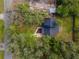 An aerial view of a home surrounded by lush greenery showcasing its private setting at 137 Stevens Ave, Chuluota, FL 32766