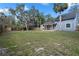 Spacious backyard featuring a covered patio and wooden perimeter fence at 137 Stevens Ave, Chuluota, FL 32766