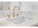 Close-up of bathroom sink featuring a gold faucet and elegant countertop at 137 Stevens Ave, Chuluota, FL 32766