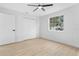 Bright bedroom with new fan, wood-look flooring and double door closet at 137 Stevens Ave, Chuluota, FL 32766