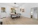 Elegant dining area with a modern chandelier, wood table, and a view of the backyard at 137 Stevens Ave, Chuluota, FL 32766