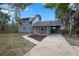 Charming two-story home with a well-manicured front yard and paved driveway at 137 Stevens Ave, Chuluota, FL 32766