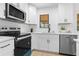 Well-lit modern kitchen with stainless steel appliances, white cabinetry and quartz countertops at 137 Stevens Ave, Chuluota, FL 32766