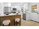 Contemporary kitchen with white cabinetry, stainless steel appliances, and a breakfast bar area at 137 Stevens Ave, Chuluota, FL 32766