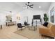 Bright living room with vaulted ceilings, modern furnishings, and a view into the dining area at 137 Stevens Ave, Chuluota, FL 32766