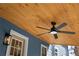 Covered back porch featuring a ceiling fan with blue exterior siding at 137 Stevens Ave, Chuluota, FL 32766