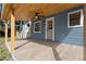 Covered patio with wood ceiling, tile floor, ceiling fan and blue siding at 137 Stevens Ave, Chuluota, FL 32766