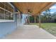 Open back porch with wooden ceiling and floor and exterior view of yard at 137 Stevens Ave, Chuluota, FL 32766