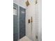 Updated shower showcasing blue and white tiles and bronze hardware at 137 Stevens Ave, Chuluota, FL 32766