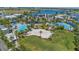 Aerial view of luxurious community pool area, volleyball court and recreational facilities amidst lush landscaping at 13838 Walcott Ave, Orlando, FL 32827