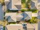 An aerial view showcases a house with a pool and patio area in a neatly arranged neighborhood at 13838 Walcott Ave, Orlando, FL 32827