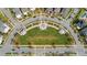 An aerial view of a landscaped community green space with fountain and surrounding modern homes at 13838 Walcott Ave, Orlando, FL 32827