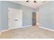 Spacious blue bedroom with carpet and wainscoting offers a closet and an exterior door at 13838 Walcott Ave, Orlando, FL 32827