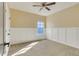 Neutral bedroom with wall trim and carpeting offers natural light from the window at 13838 Walcott Ave, Orlando, FL 32827