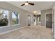 Upstairs bonus room with neutral carpeting features lots of natural light and a ceiling fan at 13838 Walcott Ave, Orlando, FL 32827