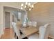 Dining room with wood panel wall and chandelier lighting at 13838 Walcott Ave, Orlando, FL 32827