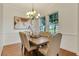 Formal dining room featuring elegant chandelier, light walls, and wood flooring at 13838 Walcott Ave, Orlando, FL 32827