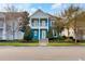 Inviting two-story blue home with a charming balcony and well-manicured landscaping at 13838 Walcott Ave, Orlando, FL 32827