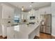 Well-lit kitchen featuring an island and stainless steel appliances at 13838 Walcott Ave, Orlando, FL 32827