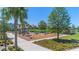 A playground with slides, climbing equipment, and a picnic area, surrounded by lush landscaping and walking paths at 13838 Walcott Ave, Orlando, FL 32827