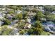 An aerial view of a home with a lush green yard and a neighboring house with a luxurious swimming pool at 1410 Osceola Ct, Orlando, FL 32806