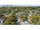 Aerial view of property outlined in red in a lush, tree-filled community near an urban skyline at 1410 Osceola Ct, Orlando, FL 32806