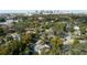 Aerial view of property outlined in red in a lush, tree-filled community near an urban skyline at 1410 Osceola Ct, Orlando, FL 32806