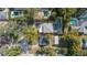 Overhead shot features a home with green yard next to a neighbor with a pool, surrounded by trees at 1410 Osceola Ct, Orlando, FL 32806